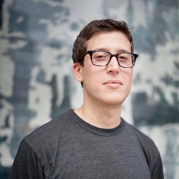 A headshot of Asher Corson